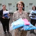 Orla Ward from O’Neills, presenting an initial batch of clothing to Foyle Women’s Aid representative Joanne Miller (left), and Denise McQuillan, for The Rowan (SARC). The local sportswear manufacturer is donating hundreds of clothing items which individuals referred to the regional centre can change into when leaving.