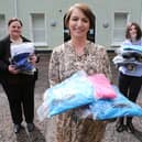 Orla Ward from O’Neills, presenting an initial batch of clothing to Foyle Women’s Aid representative Joanne Miller (left), and Denise McQuillan, for The Rowan (SARC). The local sportswear manufacturer is donating hundreds of clothing items which individuals referred to the regional centre can change into when leaving.
