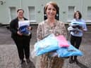 Orla Ward from O’Neills, presenting an initial batch of clothing to Foyle Women’s Aid representative Joanne Miller (left), and Denise McQuillan, for The Rowan (SARC). The local sportswear manufacturer is donating hundreds of clothing items which individuals referred to the regional centre can change into when leaving.