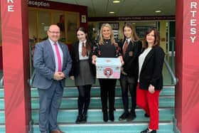 2019: Councillor Sandra Duffy with Mr McMonagle, Miss McCauley and pupils from St Brigids College delivering free period products.