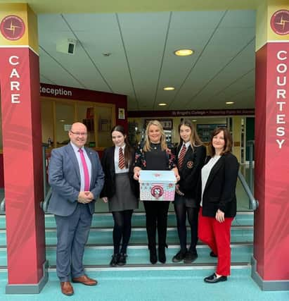 2019: Councillor Sandra Duffy with Mr McMonagle, Miss McCauley and pupils from St Brigids College delivering free period products.