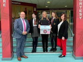 2019: Councillor Sandra Duffy with Mr McMonagle, Miss McCauley and pupils from St Brigids College delivering free period products.