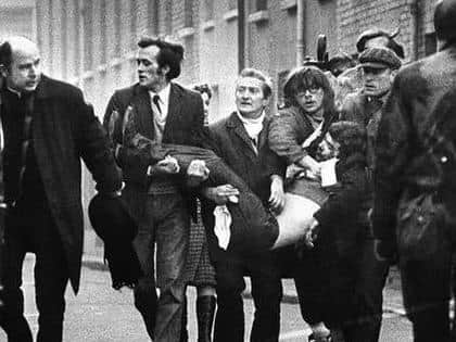 Edward Daly as Jackie Duddy is carried from the Bogside on Bloody Sunday.