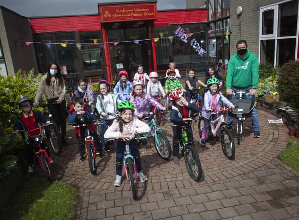 Steelstown Key Stage 1 pupils getting ready for their â€ ̃Cycle Skillsâ€TM session with Sustrans Richard Farrow on Wednesday last. Included is Miss Bronagh Lynch.
