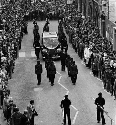 Thousands follow the hearse as Patsy O'Hara's funeral passes along the Lecky Road.