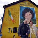 Mrs Bridie McBrearty pictured with Bogside Artist Kevin Hasson at the George McBrearty mural in Rathkeele Way at a previous commemoration. DER2217GS002