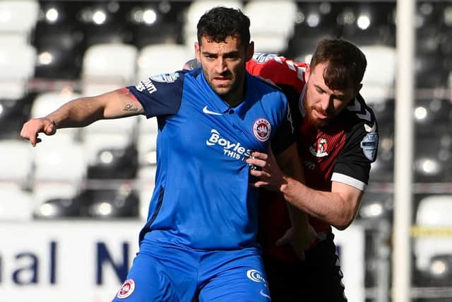 Larne striker David McDaid holds off Crusaders defender Billy Joe Burns. Picture by Stephen Hamilton/INPHO