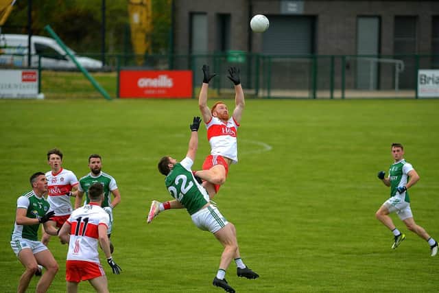 Derry's Conor Glass takes to the skies to win possession against Fermanagh at Owenbeg on Saturday. (Photo: George Sweeney)