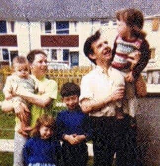 HAPPY TIMES... Harry and Bridie Duffy with some of their children outside their home in Creggan.