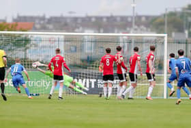 Nathan Gartside saves from Shane Griffin's free-kick at the end of the first half in Waterford. Photograph by Kevin Moore (Maiden City Images).