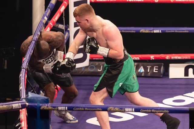 Brett McGinty lands a powerful right hand with Grant on the ropes during the Channel 5 broadcast on Saturday night.
