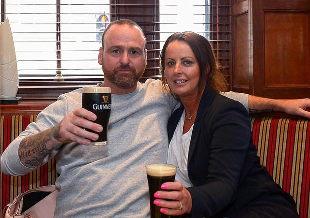 John Paul Doherty and Leona McKeever enjoy a lunch time Guinness in Badgers Bar and Restaurant yesterday afternoon as pubs reopened for indoor service. Photo: George Sweeney / Derry Journal. DER2121GS – 001