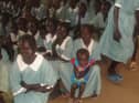 Children in new uniforms paid for by local children.