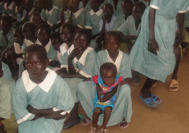 Children in new uniforms paid for by local children.