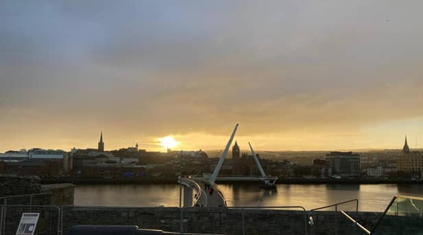 Derry city centre skyline at sunset.
