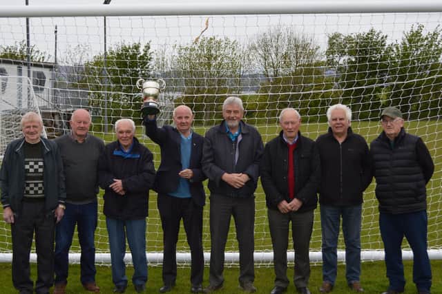 Buncrana Hearts team members from 1971 who won the McAlinden Cup and Doyle Cup double pictured with the D&D blue riband trophy 50 years on. Included in the picture are Junior Armour, Mickey Donaghey, Frankie Fletcher (Club President), Billy Porter, Jim Caldwell, Shaun Murphy (Captain), Canice Fletcher and Jim McConnell (Manager)