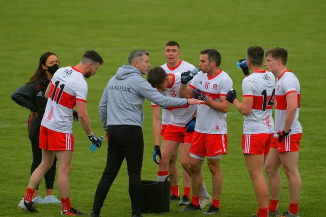 Derry manager Rory Gallagher talks to his players during the victory over Fermanagh at Owenbeg. (Photo: George Sweeney)