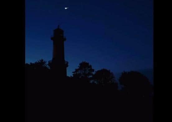 A still from Eileen McLaughlin's video of the supermoon and meteorite over Shroove lighthouse in Co. Donegal.