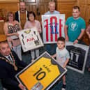 Caleb Toland who under went brain surgery earlier this year was the centre of attention during a reception in the Guidhall hosted by Mayor Brian Tierney. Caleb received signed shirts from, Harry Kane, James McClean, Robbie Keane and Patrick McEleney. included are his mum, Aine, dad Richard Jnr and sister Grace, with grandparents, Catriona Toland, Raymond Lavery, Mary Lavery and Richard Toland Snr. Picture Martin McKeown. 02.06.21