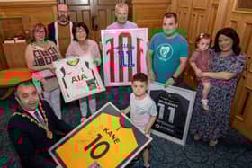 Caleb Toland who under went brain surgery earlier this year was the centre of attention during a reception in the Guidhall hosted by Mayor Brian Tierney. Caleb received signed shirts from, Harry Kane, James McClean, Robbie Keane and Patrick McEleney. included are his mum, Aine, dad Richard Jnr and sister Grace, with grandparents, Catriona Toland, Raymond Lavery, Mary Lavery and Richard Toland Snr. Picture Martin McKeown. 02.06.21