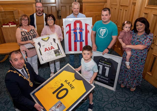 Caleb Toland who under went brain surgery earlier this year was the centre of attention during a reception in the Guidhall hosted by Mayor Brian Tierney. Caleb received signed shirts from, Harry Kane, James McClean, Robbie Keane and Patrick McEleney. included are his mum, Aine, dad Richard Jnr and sister Grace, with grandparents, Catriona Toland, Raymond Lavery, Mary Lavery and Richard Toland Snr. Picture Martin McKeown. 02.06.21