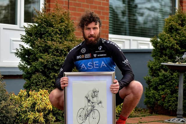 Danny Quigley, who will complete 10 ironman triathlons in 10 days, in memory of his late father, raising funds for suicide awareness pictured with a sketch of his dad. Photo: George Sweeney. DER2112GS - 003