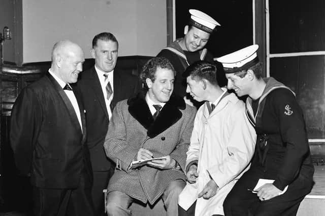 1960s... Andy McClea (second from left) pictured as Jackie Pallo - one of the greats from pro wrestling's golden era - signs autographs before an exhibition at Derry's Guildhall.