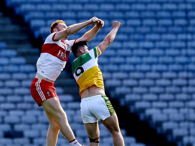 Conor Glass takes to the skies to break a high ball against Offaly's Eoin Carroll in Croke Park on Saturday. (Photo: Lorraine O'Sullivan/INPHO)
