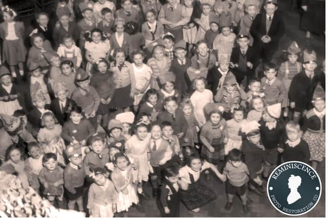 An old photograph of a children’s party in the Waterside. ‘Reminiscence - Photo Restoration Co.’ can provide restoration services.