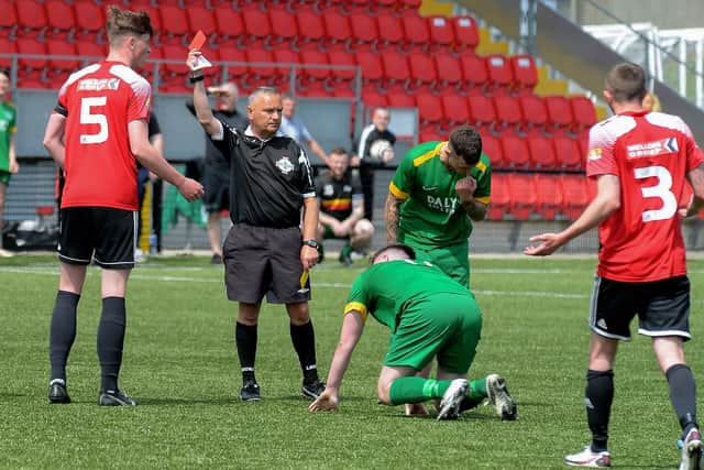 Referee Paul Doherty shows Maiden City’s Jamie Robinson during the first half of the centenary McAlinden Cup Final on Sunday afternoon last. (Photo: George Sweeney). DER2126GS - 005