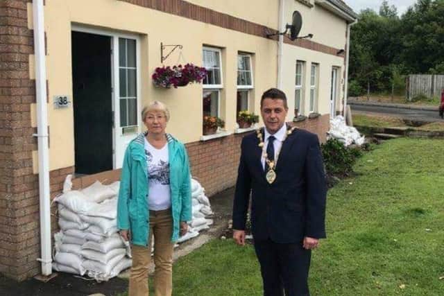 The Mayor Graham Warke and Alderman Hilary McClintock visiting homes in the Waterside affected by, or at risk of, flooding.