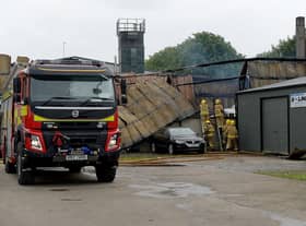 Firefighters at the scene of aftermath of the blaze on Railway Street, Strabane, that destroyed a coffin-making business on Sunday afternoon last. Photo: George Sweeney / Derry Journal.  DER2127GS – 005