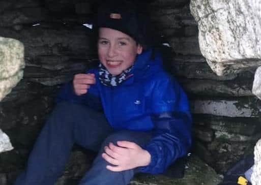 Shae inside a stone ‘igloo’ on Muckish.