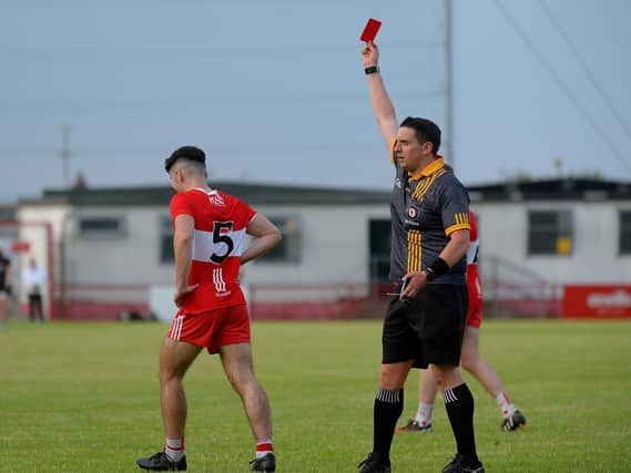 Derry’s James McGurk receives a late red card from referee Kieran Eannetta after a foul on Monaghan keeper Ryan Farrelly. (Photo: George Sweeney)