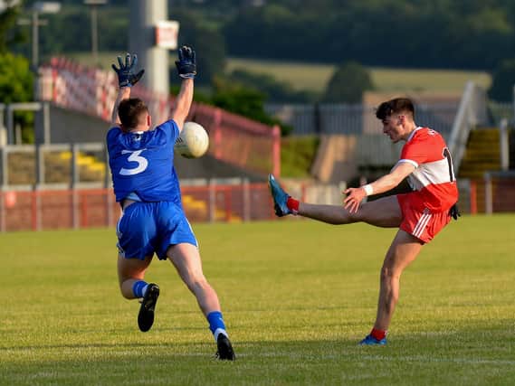 Monaghan’s Thomas McPhillips attempts to block a shot from Derry’s Conor McAteer during the Ulster Under 20 match on Friday night. (Photo: George Sweeney)