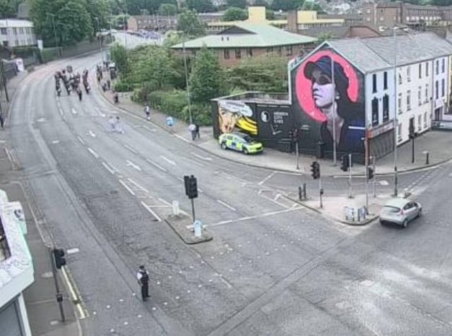 Orangemen making their way down Glendermott Road at 11.30 a.m. on Monday.
