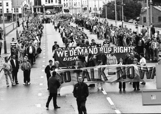 A large group of marchers make their way across the Craigavon Bridge in protest at Orange parades being forced through nationalist areas of the north.