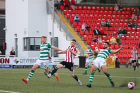 Derry sub, Jamie McGonigle attempts to get to this cross under pressure from Roberto Lopes and Liam Scales