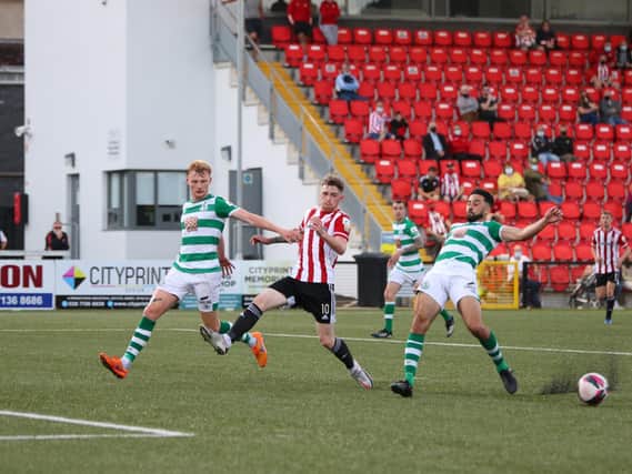 Derry sub, Jamie McGonigle attempts to get to this cross under pressure from Roberto Lopes and Liam Scales
