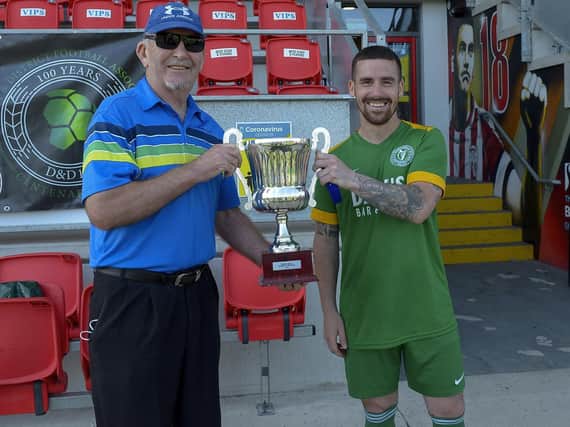 D&D Secretary Willie Barrett presents the Terry Kelly Cup to Foyle Harps’ captain Calvin McCallion after their 2-0 victory over against Top of the Hill Celtic. Picture by George Sweeney