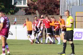 Evan McLaughlin is mobbed by his teammates after confidently converting the decisive fifth penalty in the shootout to see Derry City progress to the second round. Photographs by Kevin Moore.