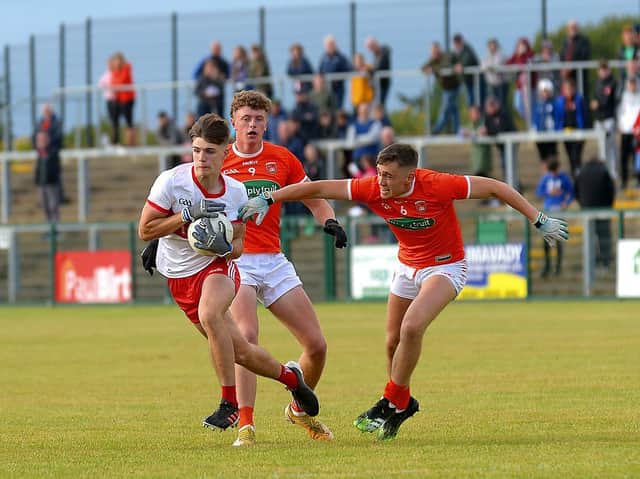 Derry’s Ryan McNicholl pulls away from Armagh’s Michael Burnett and Fergal O’Brien during Wednesday evening’s game at Owenbeg. (Photo: George Sweeney).