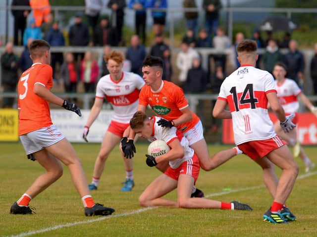 Derry’s Ruairi Forbes and Armagh’s Callum O’Neill battle for possession in Owenbeg during Wednesday evening’s game. (Photo: George Sweeney)