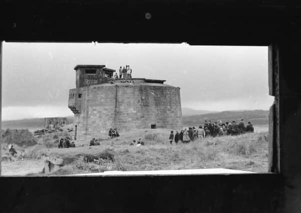 A protest at the Martello tower in Magilligan near the British army camp were local internees were held. The photograph has been taken through a loophole in a nearby fortification.