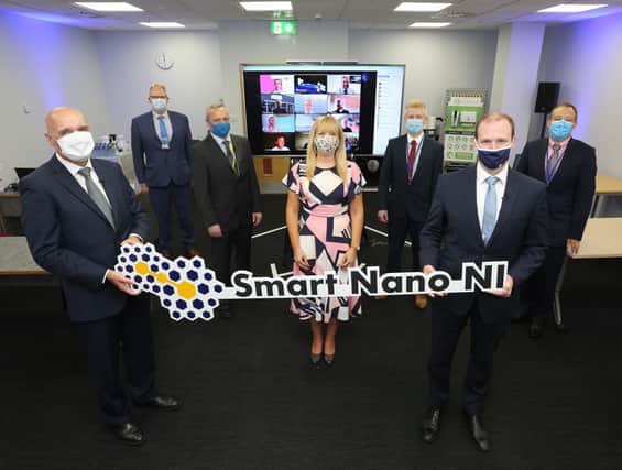 Smart Nano NI: Fergus O’Donnell, Plant Manager, Minister Gordon Lyons, Orlaith Hurley, Smart Nano NI, Mark Gubbins, Smart Nano NI, Brendan Lafferty, Seagate, David McHugh, Seagate, and Noel Brown, Invest Northern Ireland. On screen are members of the Smart Nano NI consortium