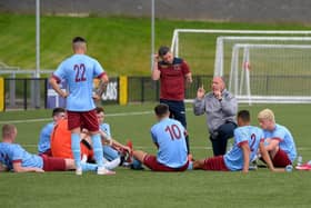 Institute boss Sean Connor and coach Sean Friars deliver a team talk at Brandywell.