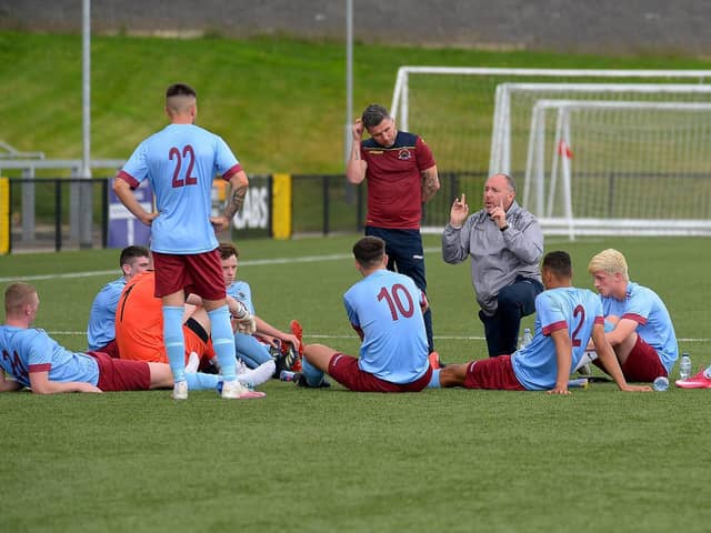 Institute boss Sean Connor and coach Sean Friars deliver a team talk at Brandywell.