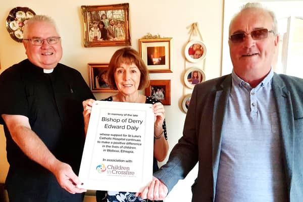 Rev. Eamon Graham, Anne Gibson and Richard Moore with a copy of the commemorative plaque.