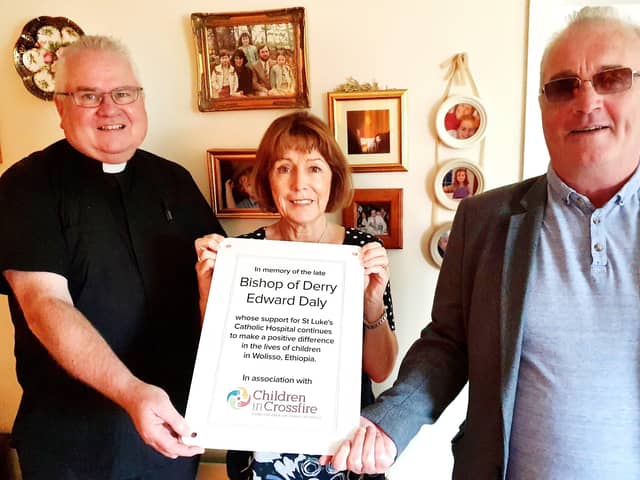 Rev. Eamon Graham, Anne Gibson and Richard Moore with a copy of the commemorative plaque.