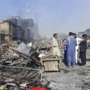 Afghans inspect damaged shops after fighting between Taliban and Afghan security forces in Kunduz city, northern Afghanistan, Sunday, Aug. 8, 2021. (AP Photo/Abdullah Sahil)